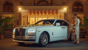 Premium decorated wedding car with a professional chauffeur outside a marriage venue in Kochi Kerala.